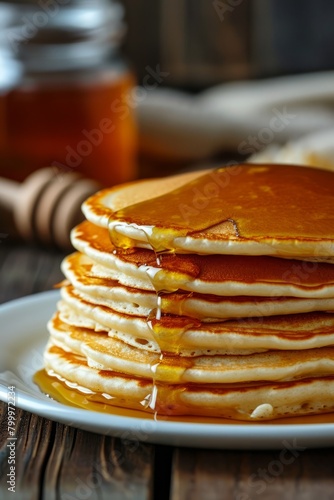 Delicious breakfast, pancakes with butter and sweet syrup.