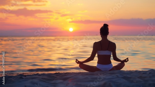 Yoga woman sitting on sea coast at sunset
