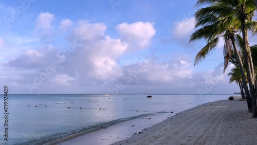 Tropical island, The sun rising from Mauritius Trou aux biches beach and the magnificent harmony of lilac colored clouds with the ocean (ID: 799974439)