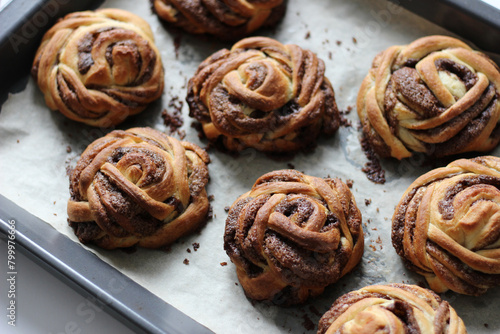 Freshly Baked Cinnamon Buns on Baking Tray. Bakery Pastry. © Iri
