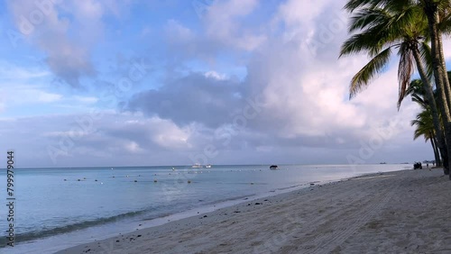 The sun rising from Mauritius Trou aux biches beach and the magnificent harmony of lilac colored clouds with the ocean (ID: 799979044)