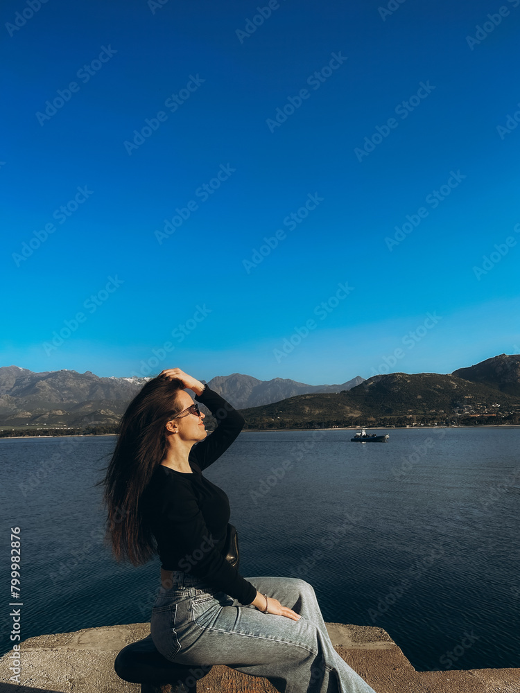 beautiful young woman on the background of the sea. Corsica. France beautiful young woman on the background of the sea. Corsica. France