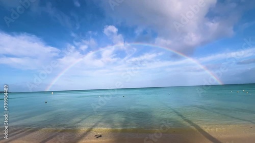 Magnificent colors of the rainbow on Trou aux biches beach on the tropical island Mauritius. a rainbow over the sea (ID: 799984489)