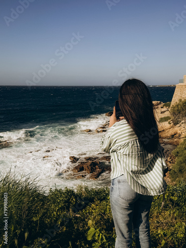 Beautiful young woman on the background of the sea. Corsica. France