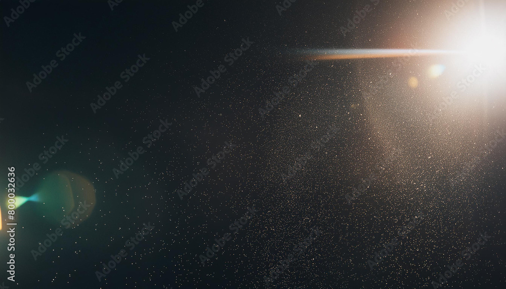 Obraz premium Designed film texture background with heavy grain, dust and a light leak Real Lens Flare Shot in Studio over Black Background. Easy to add as Overlay or Screen Filter over Photos overlay