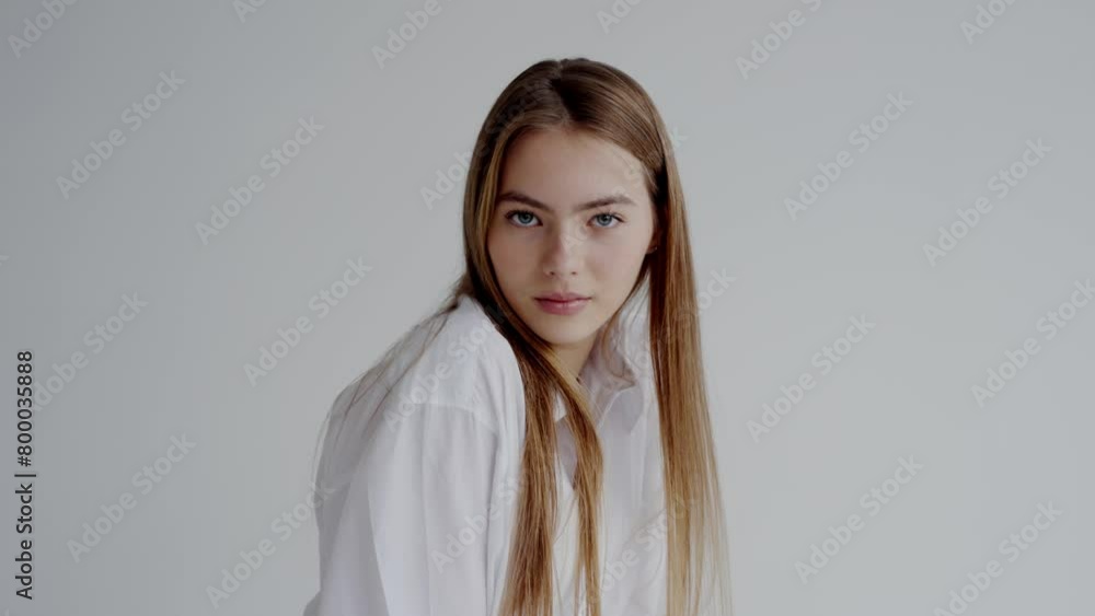 Portrait of a young woman dressed in a casual white shirt, featuring a confident, soft smile and a direct gaze. Suitable for a variety of uses in advertising, editorial content, or personal projects. Portrait of a young woman dressed in a casual white shirt, featuring a confident, soft smile and a direct gaze. Suitable for a variety of uses in advertising, editorial content, or personal projects.