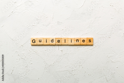 Guidelines word written on wood block. Guidelines text on table, concept