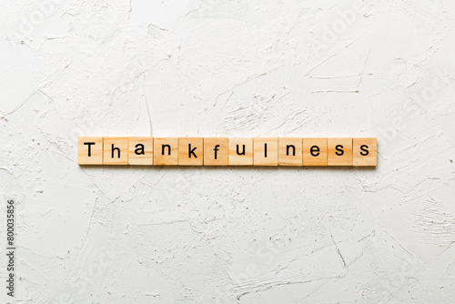 Thankfulness word written on wood block. Thankfulness text on cement table for your desing, concept