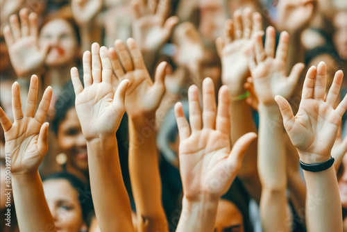 A group of people are raising their hands in the air, possibly in a celebratory or religious context