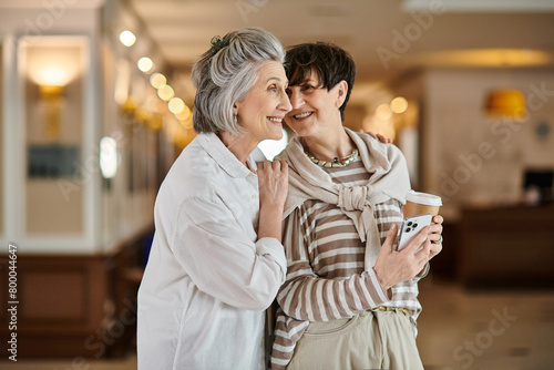 A tender moment between two senior lesbian partners in a hotel.