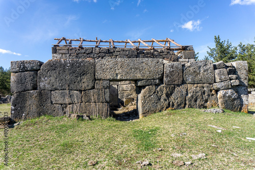 Megalithic wall and portal in front of Aia Constantine church of Tejisi village. Forest around