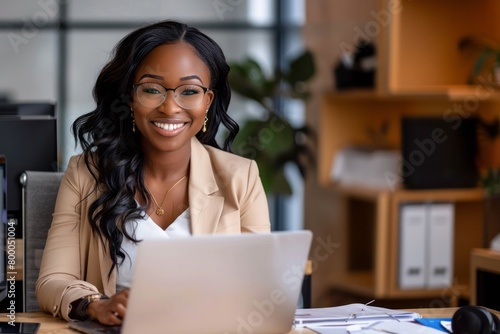 Young smiling african american businesswoman using computer at the office photo