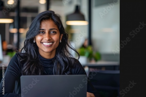 Young indian female corporate employee using laptop