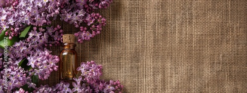 lilac essential oil on burlap background. selective focus