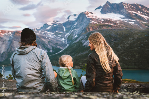Family traveling together in Norway outdoor mother, father and child on summer vacations hiking adventure tour healthy lifestyle parents with daughter enjoying mountains and fjord view © EVERST