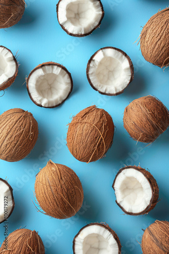 Group of coconuts arranged on a vibrant blue background creating a striking visual contrast