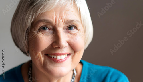 The sweet elderly woman, smiling towards the camera in close-up