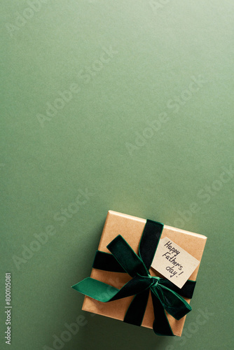 Happy Fathers Day concept. Flatlay composition with gift box on dark green background.