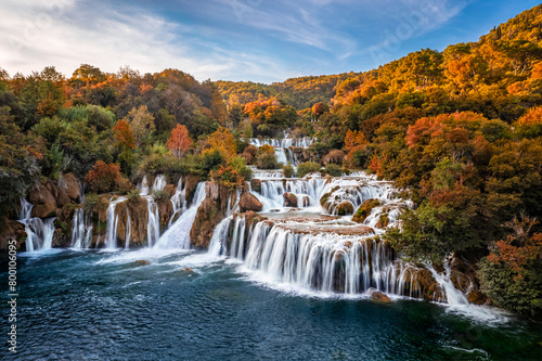 Krka, Croatia - Aerial view of the beautiful Krka Waterfalls in Krka National Park on a sunny autumn morning with colorful autumn foliage and blue sky at sunrise