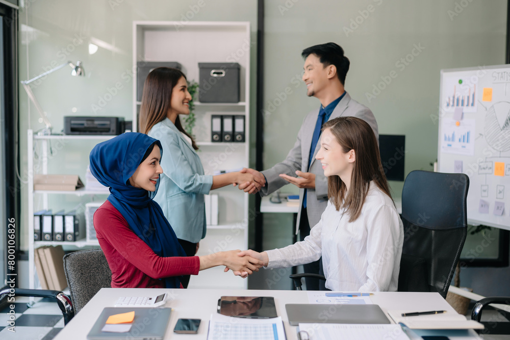 Obraz premium Business partnership handshake concept.Photo two coworkers handshaking process..