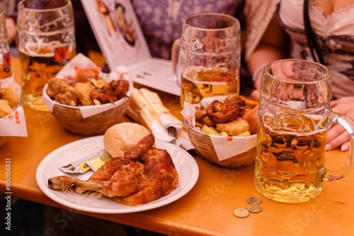 Beer and grilled chicken on the table.