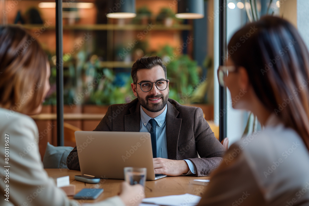 The business team was having an office meeting, discussing ideas and planning projects in the modern company conference room. The business team was having an office meeting, discussing ideas and planning projects in the modern company conference room.