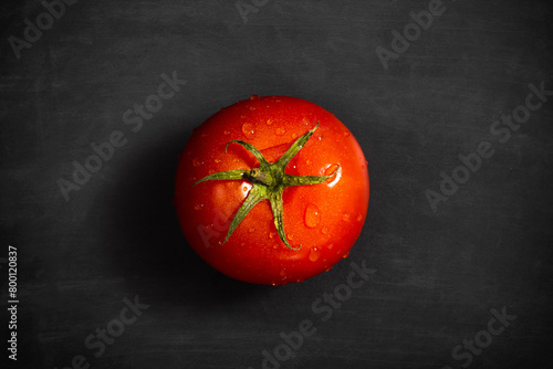 Fresh tomato with water drops on black background, Organic vegetables, top view
