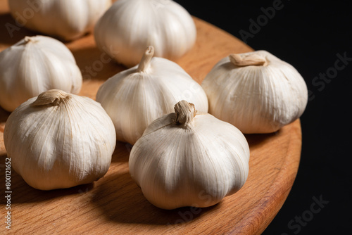 Garlic bulbs on wooden cutting board natural ingredient for local food.