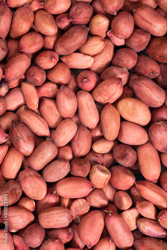 Background of raw unshelled peanuts. Nuts food background, top view
