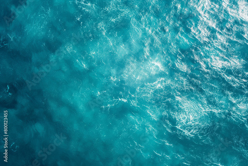 Aerial view of a turquoise water surface texture in a flat lay shot from a top down perspective in a close up