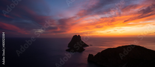 Panoramic view of Es Vedra island and Cap Jueu cape at sunset, viewed from the top of a cliff, Sant Josep de Sa Talaia, Ibiza, Balearic Islands, Spain
 photo