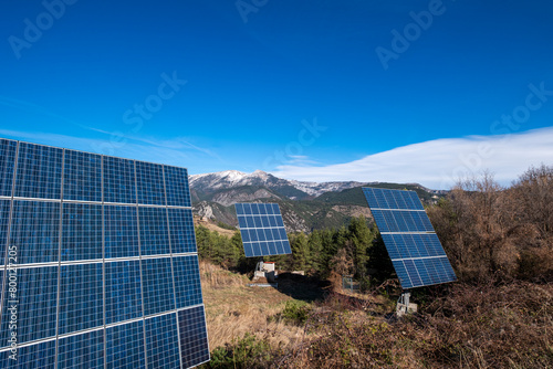 Solar energy panels stand against the stunning mountain scape of Pedraforca, highlighting Catalonia, Spain's investment in eco-friendly technologies amidst natural beauty photo