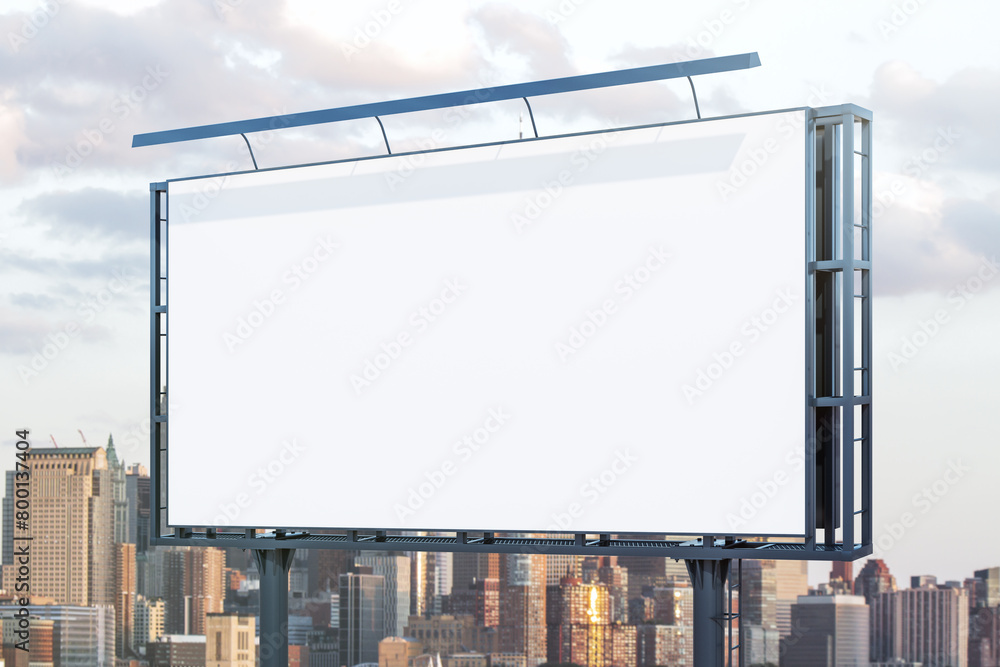 Blank white billboard on cityscape background at daytime, perspective view. Mock up, advertising concept