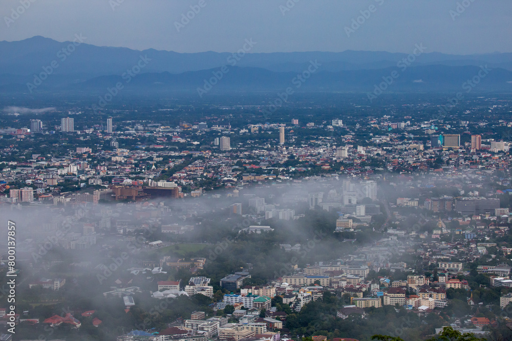 High-angle view of the city with mist passing through. Many buildings in Chiang Mai, Thailand