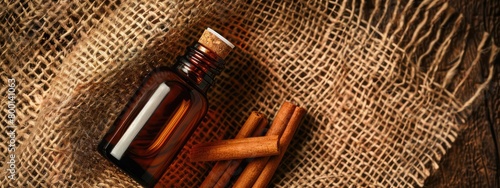 cinnamon essential oil on burlap background. selective focus