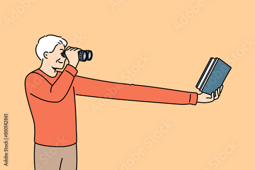 Myopic elderly man uses binoculars to read book, needs corrective surgery on eye pupils. Myopic human is looking for contacts of ophthalmologist from clinic to get advice on eyesight treatment