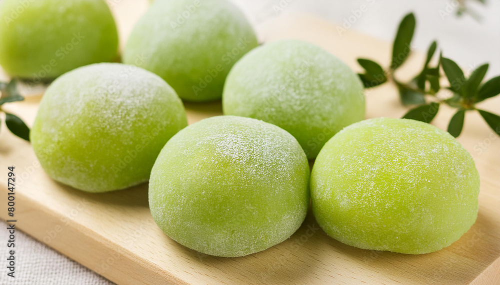 Delicious green mochi on wooden board. Traditional Japanese dessert. Rice cake. Sweet and tasty food Delicious green mochi on wooden board. Traditional Japanese dessert. Rice cake. Sweet and tasty food