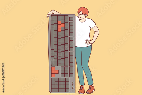 Woman is holding large computer keyboard, encouraging you to become freelancer and work remotely. Girl leans on keyboard to type articles for online magazines or email messages for colleagues.