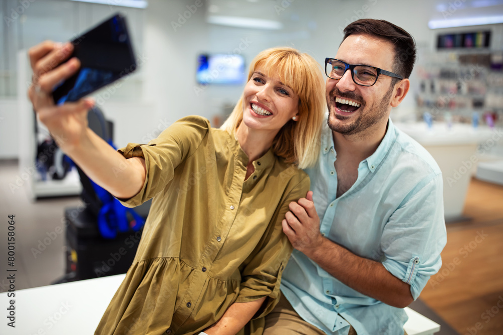 Couple is making selfie using a smart phone. Digital device, artificial intelligence concept. Couple is making selfie using a smart phone. Digital device, artificial intelligence concept.