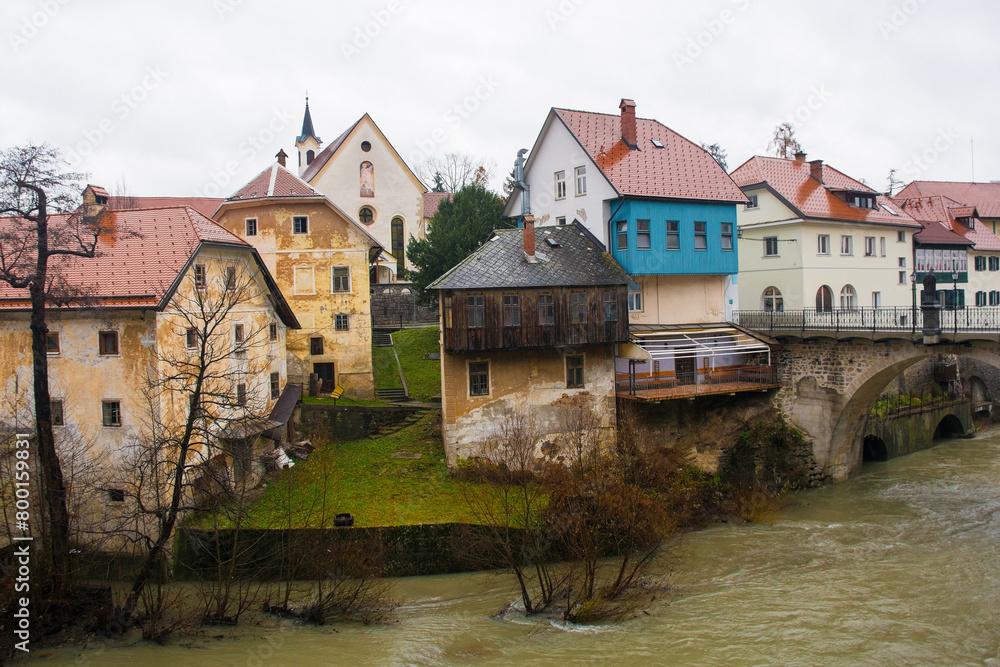 A wet December day in Skofja Loka in Gorenjska, Slovenia. On the far right, the Capuchin Bridge crossing the Selska Sora river as it flows through the historic centre