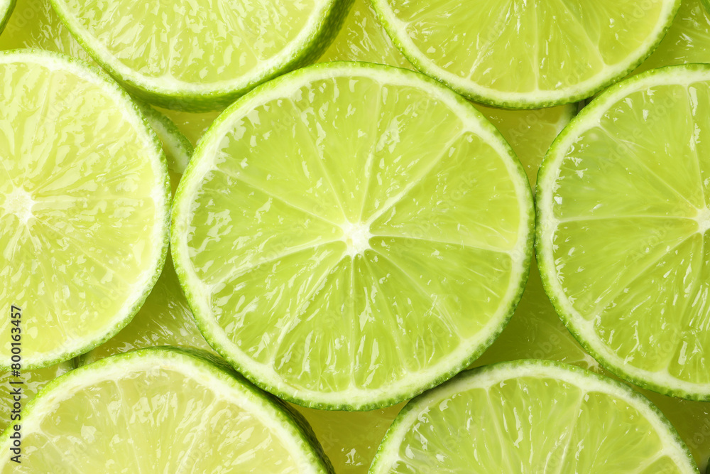 Fresh juicy lime slices as background, top view Fresh juicy lime slices as background, top view
