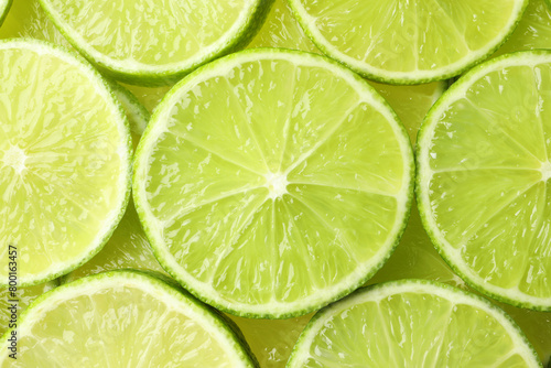 Fresh juicy lime slices as background, top view