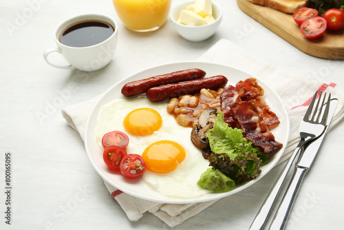 Delicious breakfast with sunny side up eggs served on white table