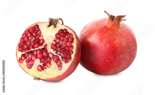 Half and whole pomegranates isolated on white