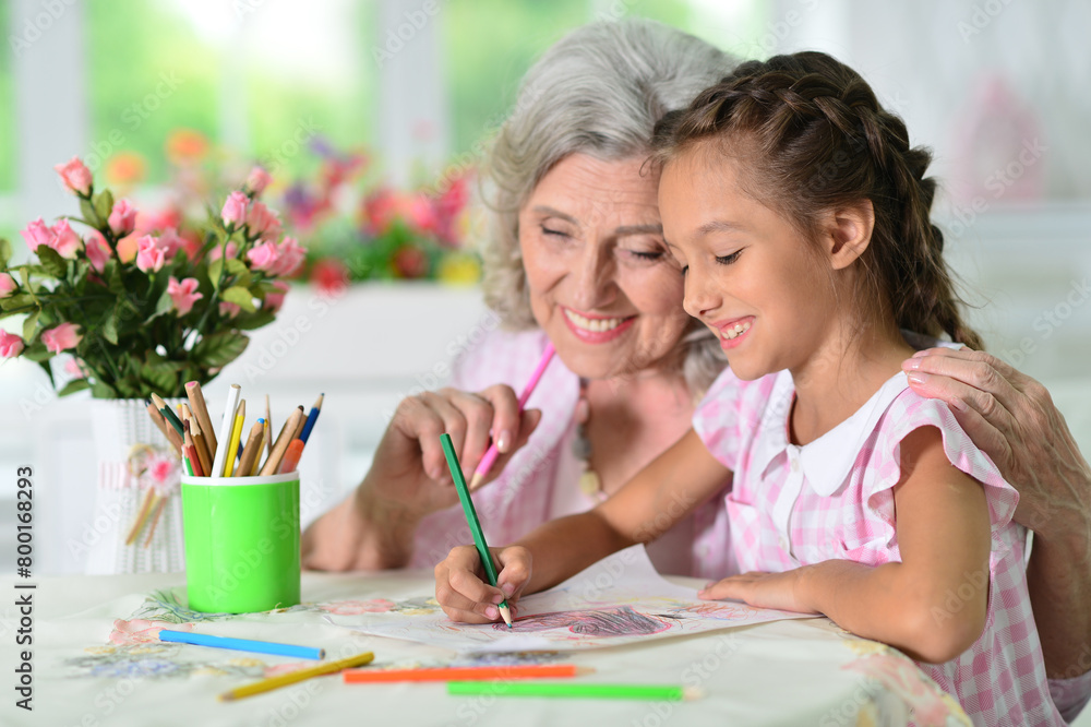 Portrait of a cute little girl drawing with her grandmother Portrait of a cute little girl drawing with her grandmother