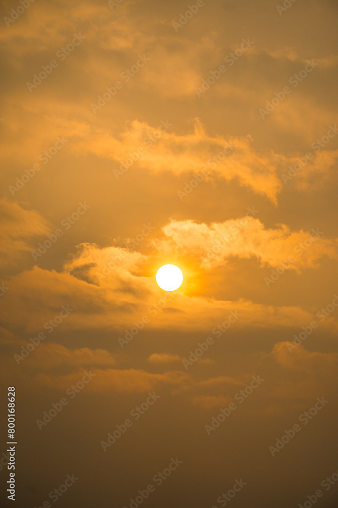 The sun is shining through the clouds, creating a warm and peaceful atmosphere