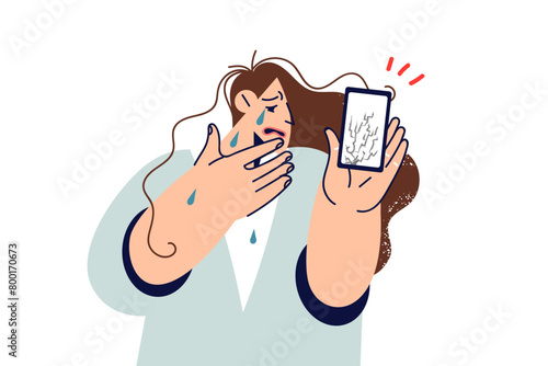 Crying woman demonstrates phone with broken display or protective film after gadget fell to ground