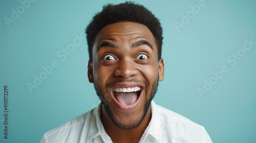 Giddy with excitement joy concept, young african american man with surprised expression on his face, portrait lifestyle facial expression toothy smile confidence