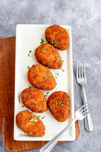 Fried  Crispy Vegetable Cutlet Garnished with Cilantro Top Down Vertical Photo