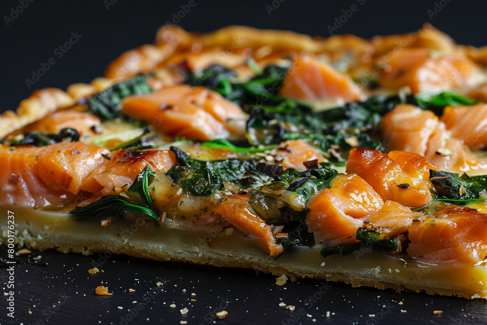 salmon tart with spinach on a black background salmon tart with spinach on a black background